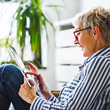 Senior woman using digital tablet at home. The use of technology by the elderly.